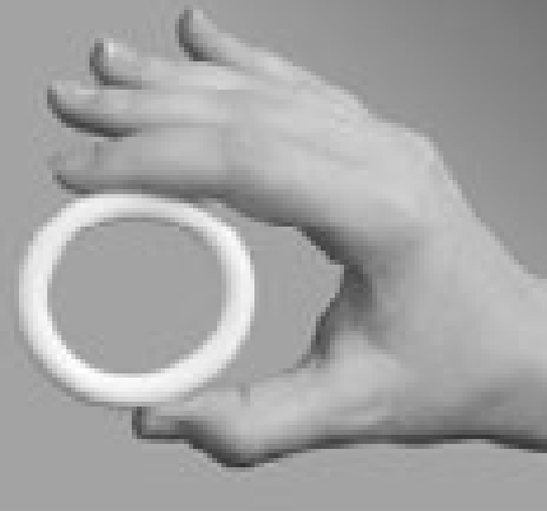 A hand holding up a Progesterone-Releasing Vaginal Ring